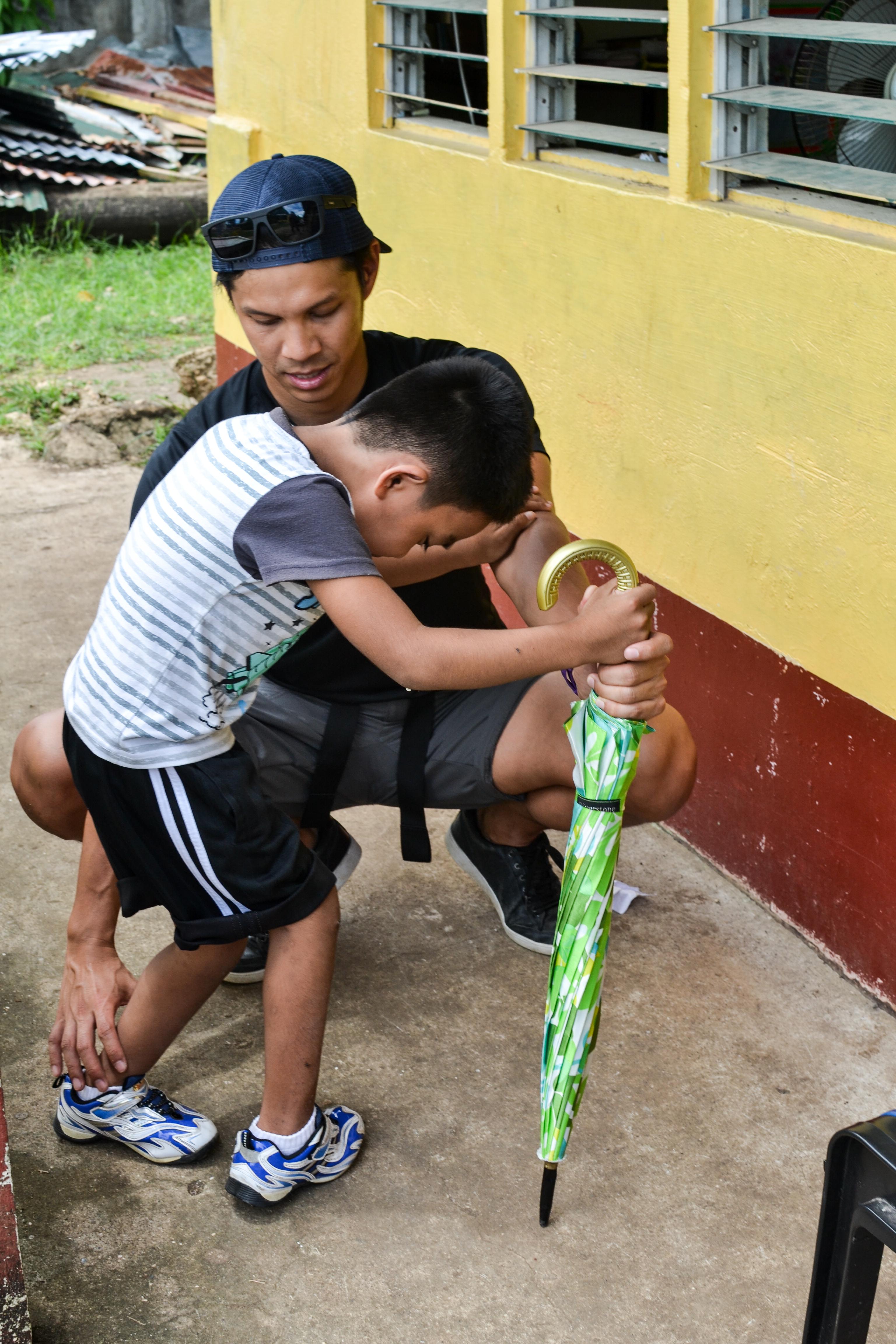 A male intern from Projects Abroad teaching a child how to walk and straighten his legs whilst on his physiotherapy internship in the Phillippines. A male intern at Projects Abroad assisting a child with walking and straightening his legs whilst on his physiotherapy internship in the Phillippines.